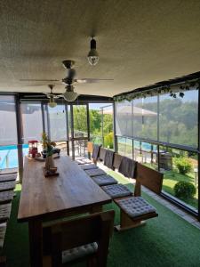 a dining room with a large wooden table and chairs at Aura Lux Holiday Home with Pool in Lopatinec