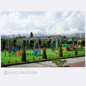 a playground in a park with a playground at Townhouse 4/11 in Bosteri