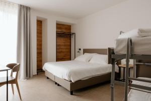 Postel nebo postele na pokoji v ubytování Belladonna Hotel
