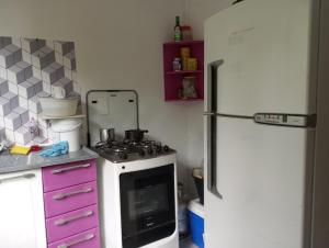 a kitchen with a stove and a refrigerator at Casa famíliar agradável in Rio de Janeiro
