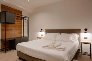 Un pat sau paturi într-o cameră la Belladonna Hotel