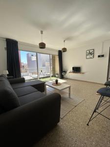 a living room with a couch and a table at Médano Beach Blue in El Médano