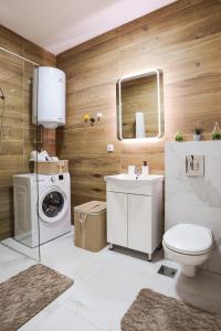 uma casa de banho com um lavatório e uma máquina de lavar roupa em Airport Belgrade Apartments em Surčin