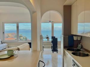 a kitchen with a view of the ocean at [porto santo stefano] vista mare + parcheggio gratuito in Porto Santo Stefano