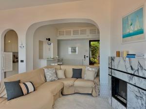 a living room with a couch and a fireplace at [porto santo stefano] vista mare + parcheggio gratuito in Porto Santo Stefano