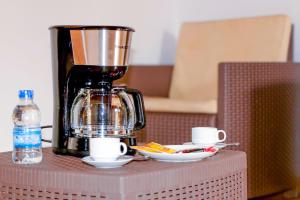 a coffee maker sitting on top of a table at Sabbat Plage in Assinie