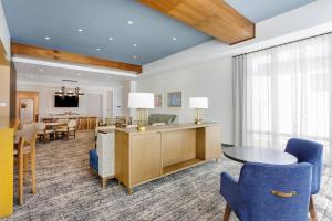 a living room with a table and chairs and a dining room at Staybridge Suites Winter Haven - Auburndale in Winter Haven