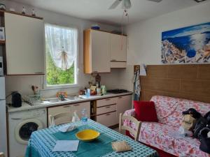 a kitchen with a table and a couch in a kitchen at Patty's Cottage with private PARKING in Lerici