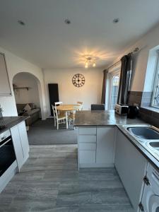a kitchen and dining room with a table at Hinckley Home Leysmill in Hinckley