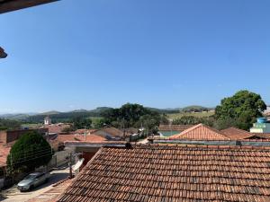 a view from the roof of a town with red tile roofs at Casarão Hostel in Guaratinguetá