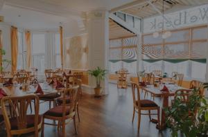 a dining room with tables and chairs in a restaurant at Welbeck Hotel & Apartments IOM in Douglas