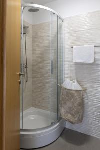 a shower with a glass door in a bathroom at Stephanie green island apartments in Šipanska Luka