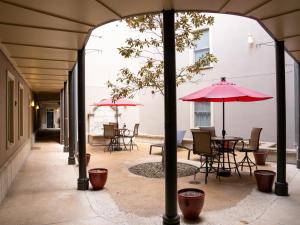 an outdoor patio with tables and chairs and umbrellas at Gallery Guest in Fayetteville