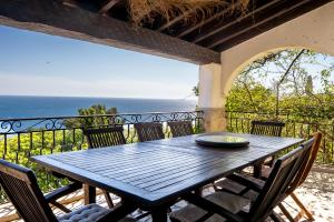Villa prestige (voiture plage) في كاركيران: طاولة خشبية على شرفة مطلة على المحيط