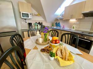 a table with a plate of food on it in a kitchen at Apartmány Pálava Novosedly in Novosedly