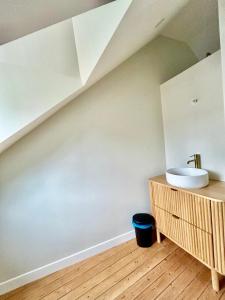a bathroom with a sink and a wooden counter at Les hirondelles de Deauville in Deauville +18 photos