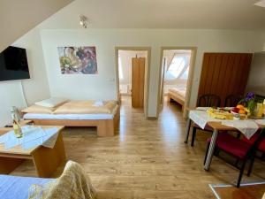 a room with two beds and a table with fruits on it at Apartmány Pálava Novosedly in Novosedly