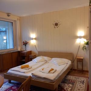 a bedroom with a bed with two towels on it at chez Chany in Merano