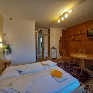 a bedroom with a white bed and a table at chez Chany in Merano