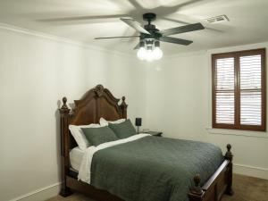 a bedroom with a bed with a ceiling fan at Gallery Guest in Fayetteville