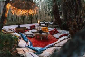 a garden with a large couch with pillows at L'Ma Lodge in Skoura