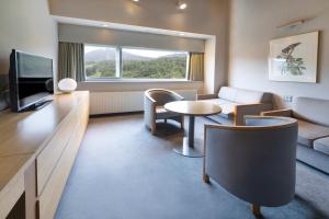 a living room with a couch and a table at ANA Crowne Plaza Resort Appi Kogen by IHG in Hachimantai +143 photos