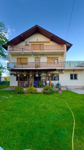 a large house with a lawn in front of it at Dhabi Sweet Home in Doglodi