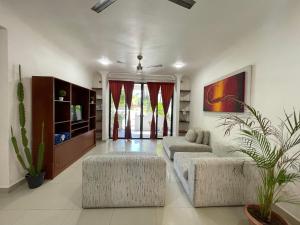 uma sala de estar com dois repousa-pés e dois sofás em Amaranta Beach em Playa del Carmen