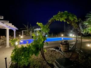 a view of a swimming pool at night at Sicily Stone Cottage in Graniti