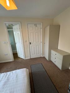 a bedroom with a bed and a dresser and a closet at Double rooms in Milton