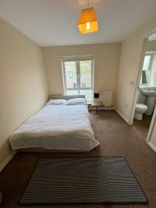 a bedroom with a bed and a bathroom with a sink at Double rooms in Milton