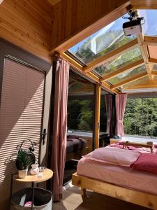 a bedroom with a bed and a large window at Ria süit otel bungalov in Rize