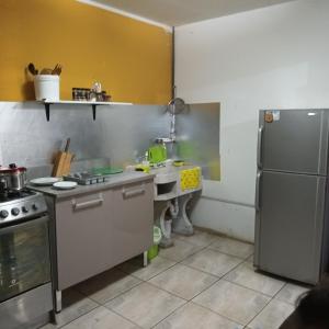 a kitchen with a sink and a refrigerator at Starfish of Paracas in Paracas