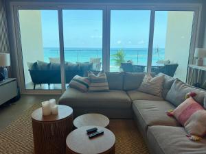 a living room with a couch and a view of the ocean at Delux Oceanview on the Caribbean @ Playa Escondida Resort in María Chiquita