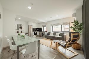 a dining room and living room with a table and chairs at Amazing Villa by Hosty in Porto
