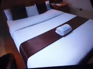 two beds in a hotel room with a towel on them at Villa toscana Victoria island oniru in Lagos