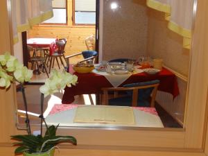 a table and chairs in a room with a dining room at Schlummerburg in Weißkirchen in Steiermark