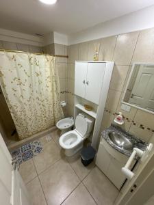 a small bathroom with a toilet and a sink at Rincón Montañas del Sur in Ushuaia +17 photos