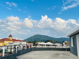 a balcony with a view of a city and mountains at Urban Haven Rooms in Iringa