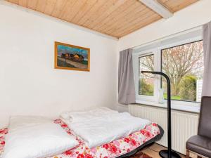 a bed in a room with a window at 9 person holiday home in Thyholm-By Traum in Thyholm