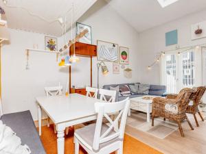 a dining room and living room with a table and chairs at Holiday home Vestervig L in Vestervig