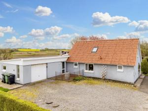 a white house with an orange roof at 9 person holiday home in Thyholm-By Traum in Thyholm