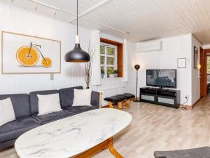 a living room with a couch and a tv at 4 star holiday home in Øster Assels-By Traum in Øster Assels
