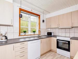 a kitchen with white appliances and a window at Holiday home Øster Assels III in Øster Assels