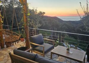 une terrasse avec une chaise et une table et l'océan dans l'établissement Villa Tramonto D'Oro, à Ulcinj