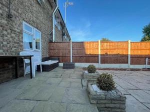 a patio with a white door and a fence at Lovely 3 bedroom house near city centre - Basildon in Basildon