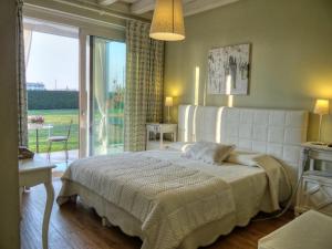 a bedroom with a large bed and a large window at B&B La Magia dei Sogni Relais in Verona