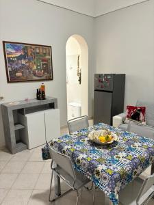 a kitchen with a table with a plate of fruit on it at La Casetta di Romeo in Trapani