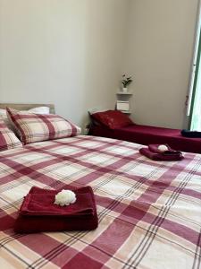 a bedroom with two beds with towels on them at La Casetta di Romeo in Trapani