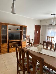 een woonkamer met een houten tafel en stoelen bij Casa Aurora in Olavarría